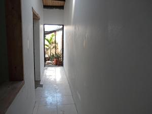 a hallway with a white wall and a tile floor at La Victoria, Valle te espera in La Victoria