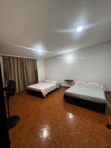 a room with two beds and a window in it at Villa Gabritali in La Mesa +26 photos