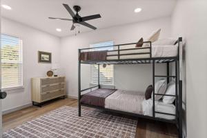 Un dormitorio con dos literas y un ventilador de techo. en Group Ready! 3BR Home Near WinStar, en Thackerville