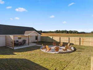 a backyard with a patio with chairs and a table at Group Ready! 3BR Home Near WinStar in Thackerville