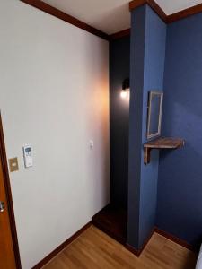 a room with a blue and white wall and a shelf at sneaky peaks in Hakuba