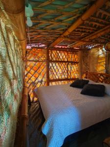 a bedroom with a bed in a wooden structure at Hospedaje casa en el Árbol in Moniquirá +14 photos