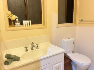 a bathroom with a sink and a toilet at Tranquil Hideaway in Mudgeeraba in Gold Coast +8 photos