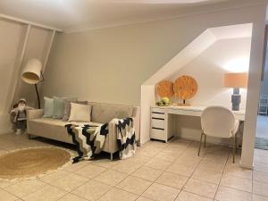 a bedroom with a bed and a desk in a room at Tranquil Hideaway in Mudgeeraba in Gold Coast