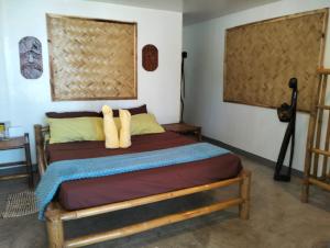 Ένα ή περισσότερα κρεβάτια σε δωμάτιο στο EL Nido Bucana Beach House