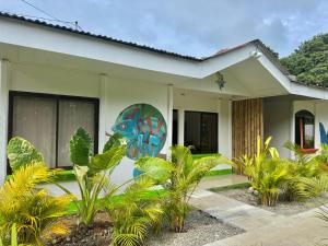a house with a painting on the side of it at Kalunay Hostel - Breakfast included in Puerto Viejo