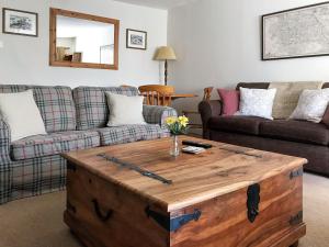 a living room with a couch and a coffee table at Lightfoot House in Redmire