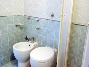 a bathroom with a toilet and a sink at Romantic Stay Near Velia in Marina di Ascea