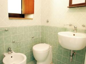 a bathroom with a toilet and a sink at Villa in Velia near Roman Ruins and Beach in Marina di Ascea