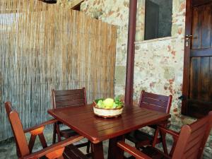 a wooden table with a basket of fruit on it at Villa in Velia near Roman Ruins and Beach in Marina di Ascea