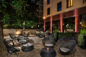 a patio with chairs and tables in front of a building at Starhotels Ritz in Milan