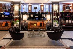 a living room with two chairs and a couch at Starhotels Ritz in Milan