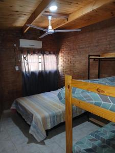 a bedroom with two beds and a ceiling fan at Finca La Huella II in Santiago del Estero +21 photos