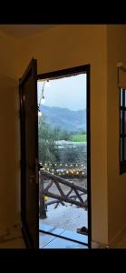 an open door to a balcony with a view at عزبة وادي السدر in ‘Ashashah