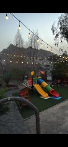 a playground with a slide in a park at عزبة وادي السدر in ‘Ashashah