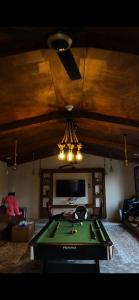 a living room with a pool table and a tv at عزبة وادي السدر in ‘Ashashah +9 photos