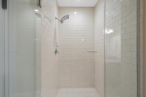 a bathroom with a shower with a glass door at Westcott 3 Bed Apt in Mansion mins to SU JMA Dome in Syracuse +28 photos