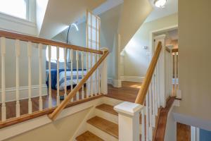 a staircase in a home with wooden railings at Westcott 3 Bed Apt in Mansion mins to SU JMA Dome in Syracuse