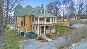 a large yellow house with a green roof at Westcott 3 Bed Apt in Mansion mins to SU JMA Dome in Syracuse