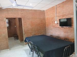 a dining room with a black table and chairs at Finca La Huella II in Santiago del Estero