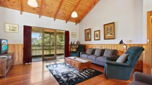 a living room with a couch and a tv at Halcyon - Peaceful Family Retreat in Nungurner