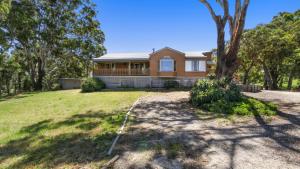 a large house with a tree in the yard at Halcyon - Peaceful Family Retreat in Nungurner