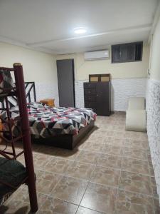a bedroom with a bed and a dresser in it at la pipi in Las Heras +23 photos