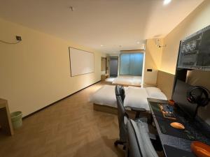 a hotel room with a bed and a desk with a desk at Hulk Esports Cinema Hotel Guiyang Fountain Pool Branch in Guiyang +16 photos