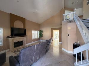 a living room with a couch and a fireplace at South OC House in Laguna Niguel