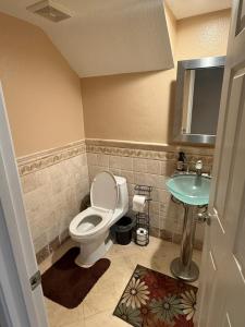 a bathroom with a toilet and a sink at South OC House in Laguna Niguel +7 photos