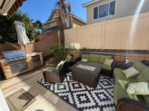 a patio with a couch and a table at South OC House in Laguna Niguel