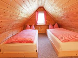 two beds in a log cabin with a window at Ferienwohnung, Oberkirchen in Schmallenberg