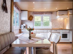 a kitchen with a table and chairs in a room at Ferienwohnung, Oberkirchen in Schmallenberg
