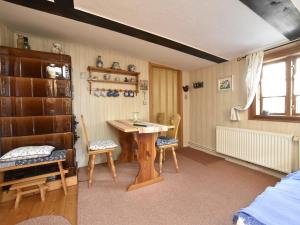 a room with a wooden table and two chairs at Séjour sérénité au bord du lac de Granzow in Gegensee