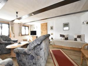 a large living room with a bed and a couch at Séjour sérénité au bord du lac de Granzow in Gegensee