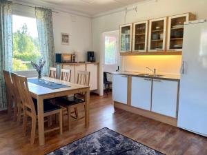 a kitchen with a dining table and a refrigerator at 5 person holiday home in Mörlunda-By Traum in Tulunda +9 photos