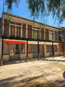 an empty school building with an orange roof at la pipi in Las Heras