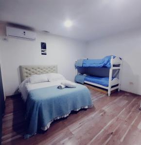 a small bedroom with a bed and a chair at Oceana Suites Elisio Mouriño in La Unión