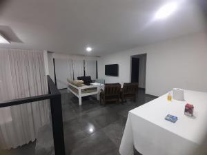 a living room with a white table and a couch at Oceana Suites Elisio Mouriño in La Unión