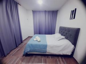 a bedroom with a bed with two pillows on it at Oceana Suites Elisio Mouriño in La Unión +3 photos
