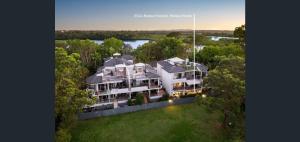 an aerial view of a large white house with trees at Riviera Noosa Resort in Noosaville