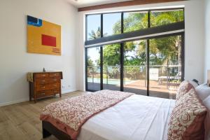 a bedroom with a bed and a large window at The Barrington in South Mission Beach +38 photos