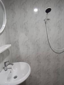 a bathroom with a white sink and a shower at Lanta summer house nui bay in Ko Bu Bu +2 photos