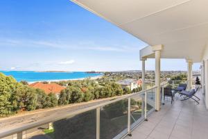 a view of the ocean from the balcony of a house at 13 The Crescent - BYO Linen - Ocean Views - Wi-Fi in McCracken