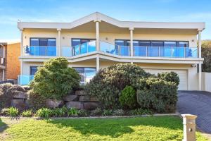 a house with a balcony on top of it at 13 The Crescent - BYO Linen - Ocean Views - Wi-Fi in McCracken +28 photos