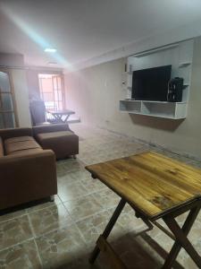 a living room with a couch and a table and a tv at alojamiento la pipi in Las Heras +39 photos