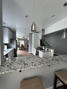 a kitchen with white cabinets and a counter top at Cozy and stylish 3BR house in Tacoma