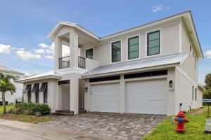 a white house with a fire hydrant in front of it at 119 Ocean Estates Dr in Lakewood Park