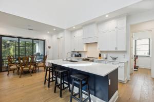 a kitchen with white cabinets and a table and chairs at 119 Ocean Estates Dr in Lakewood Park