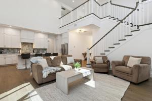 a living room with two couches and a staircase at 139 Ocean Estates Dr in Lakewood Park